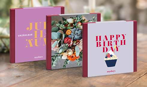 Geschenkverpackungen mit Aufschrift "Jubiläum", "Dankeschön" und "Happy Birthday"